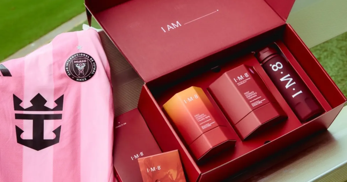 An Inter Miami CF pink shirt beside an open red IM8 box of supplements