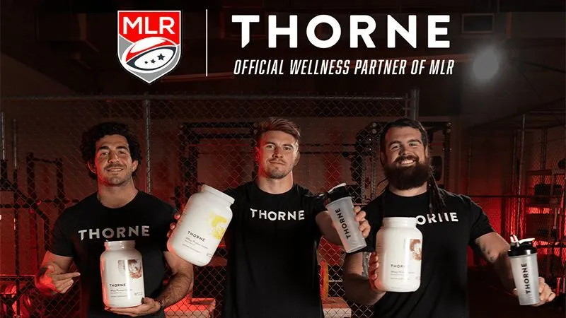 Three rugby players in Thorne shirts holding Thorne tubs under a banner reading Thorne, official wellness partner of MLR