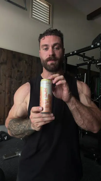 Chris Bumstead holding a Bum Energy can