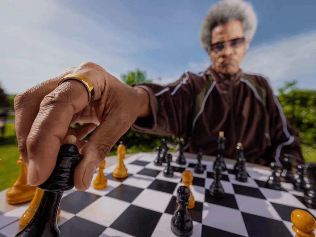 An older person moving a chess piece, for Oura's campaign about aging well.