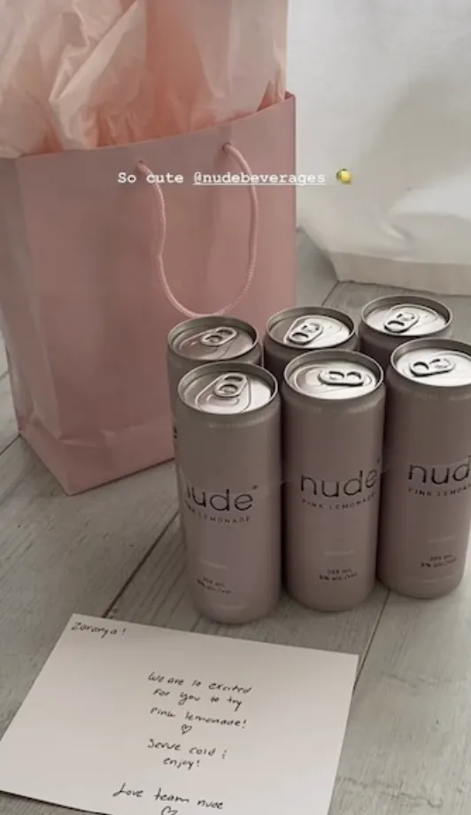 A creator's gifted six pack of Nude Beverages cans, with a note