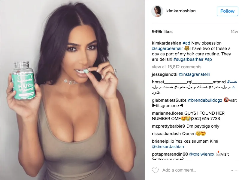 Kim Kardashian's sponsored Instagram post holding the SugarBearHair bottle, tagged #ad and #sp.