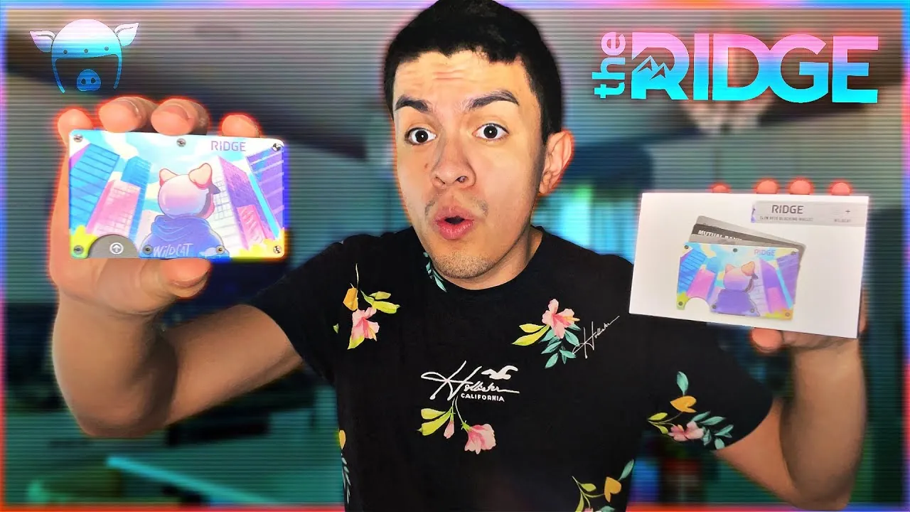 a real creator holding a Wildcat x Ridge wallet in one hand and its retail box in the other