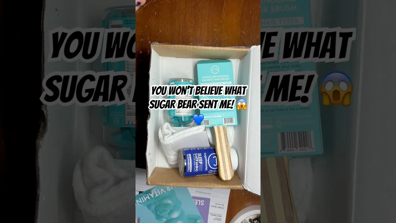A creator's own unboxing of a SugarBearHair PR box: vitamin bottles, a hair brush and a detangling-brush box, captioned “you won't believe what sugar bear sent me”
