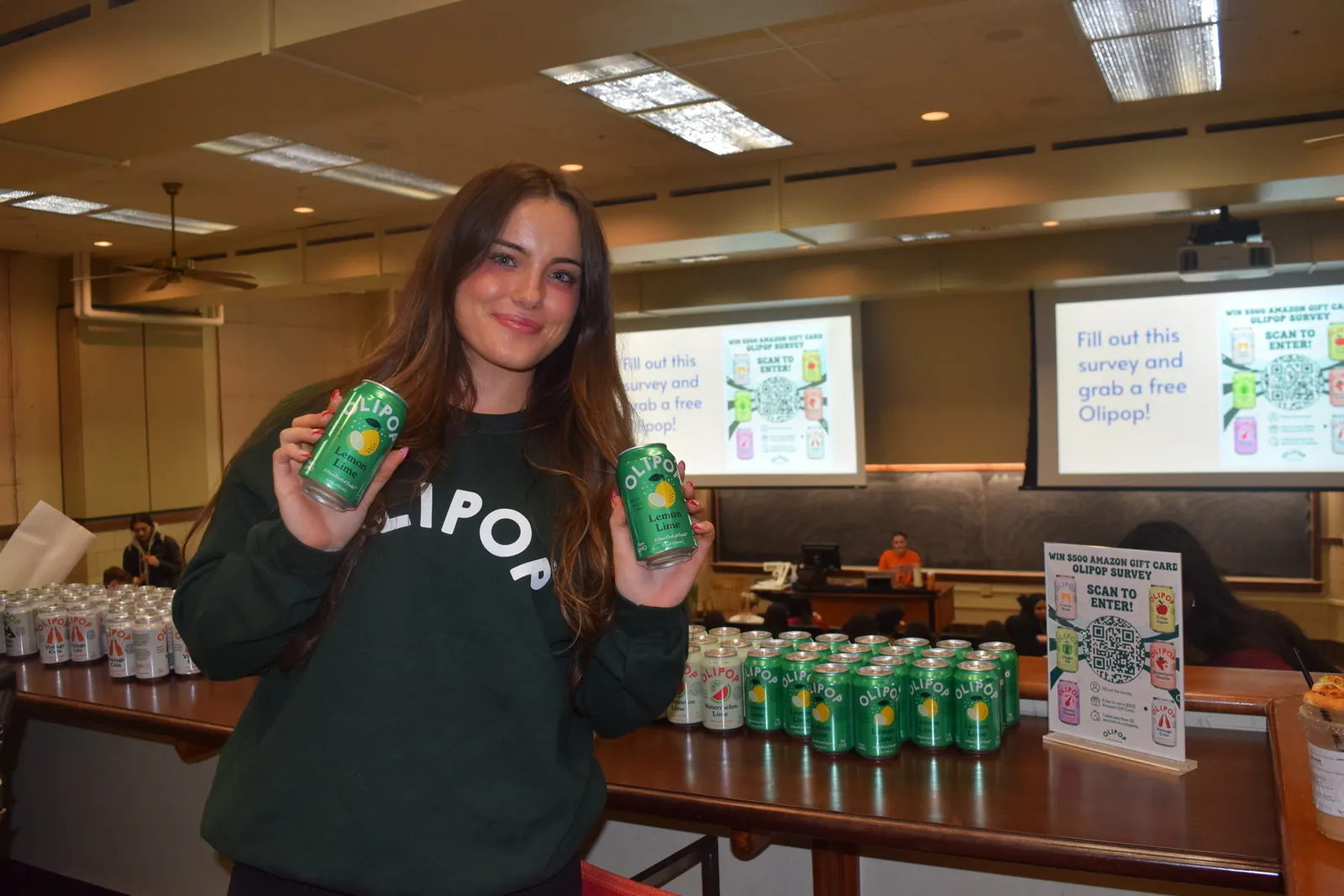 an Olipop campus ambassador sampling event in a lecture hall, with a sign-up survey for a $500 gift card