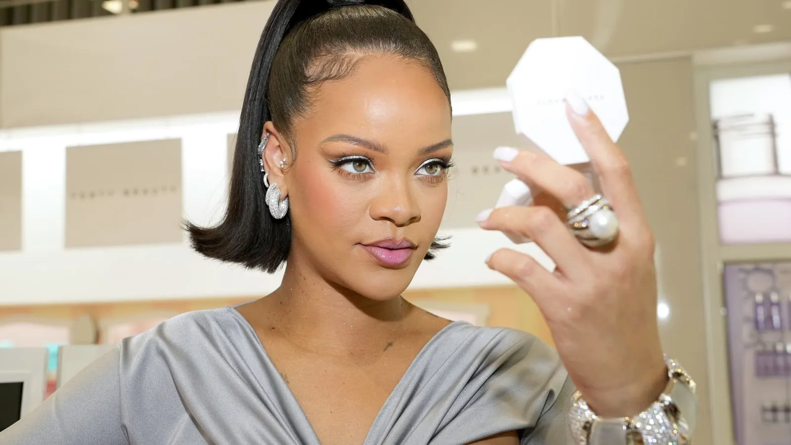 Rihanna holding a Fenty Beauty compact