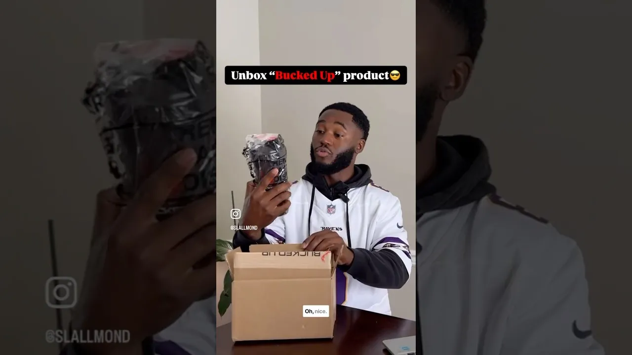 a real creator holding a Bucked Up product over an open cardboard box