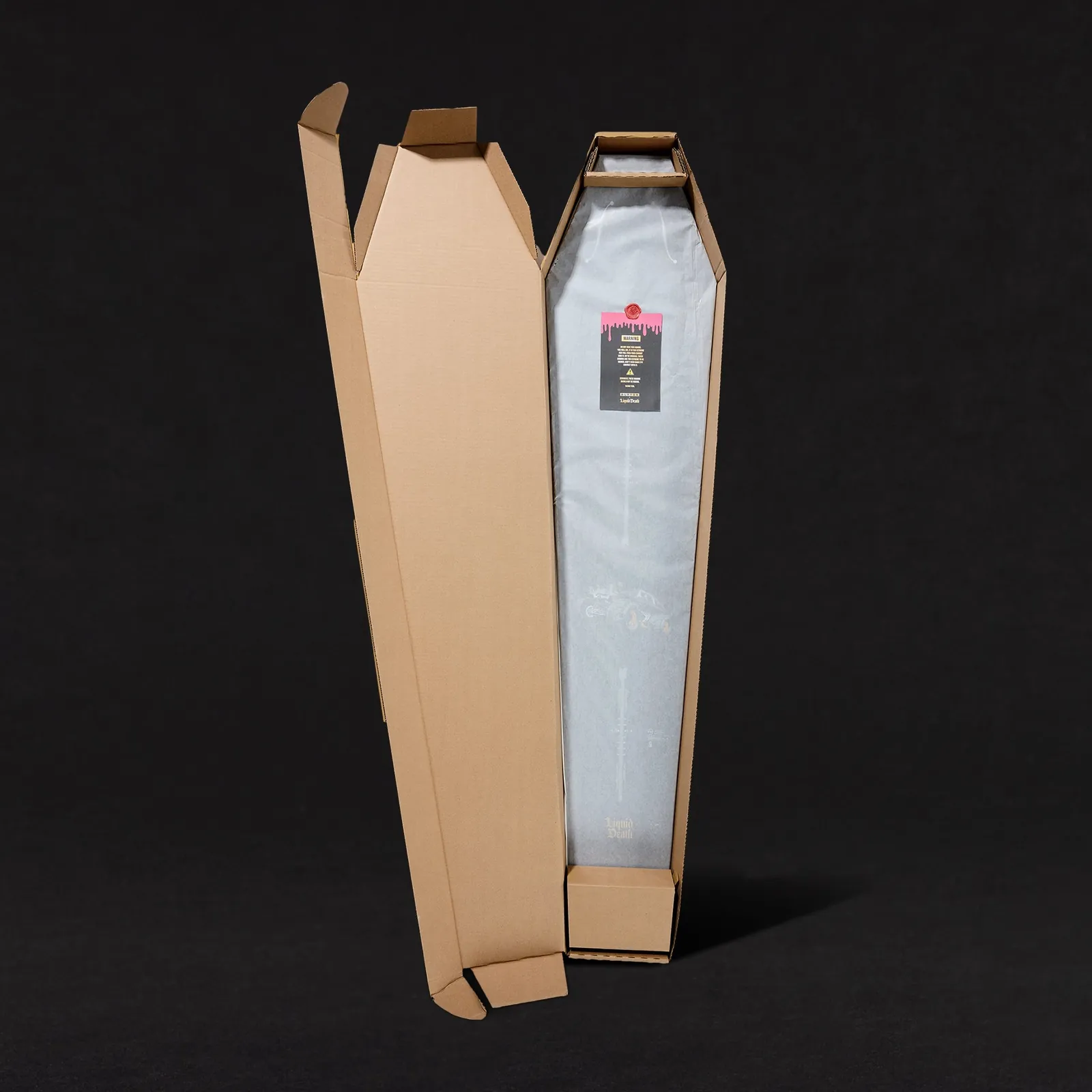 the real coffin-shaped shipping box a custom Liquid Death snowboard ships in