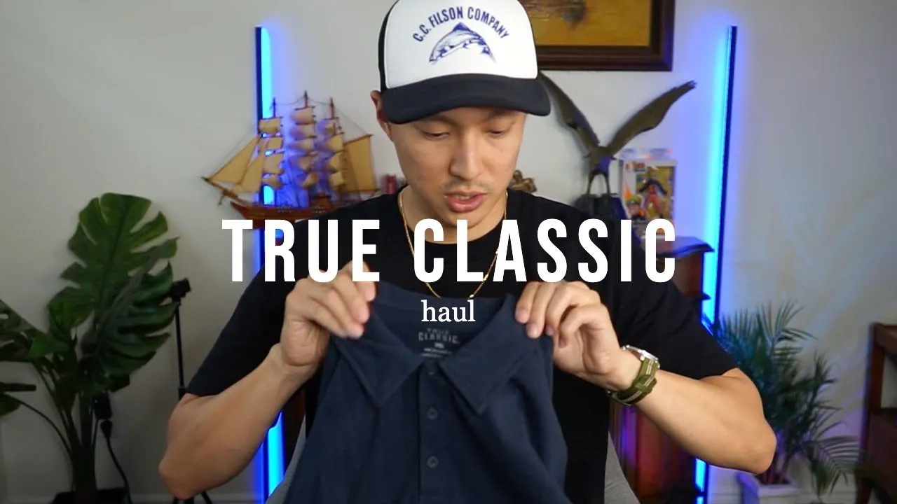 a real creator holding up a True Classic polo shirt, the True Classic logo on the collar tag