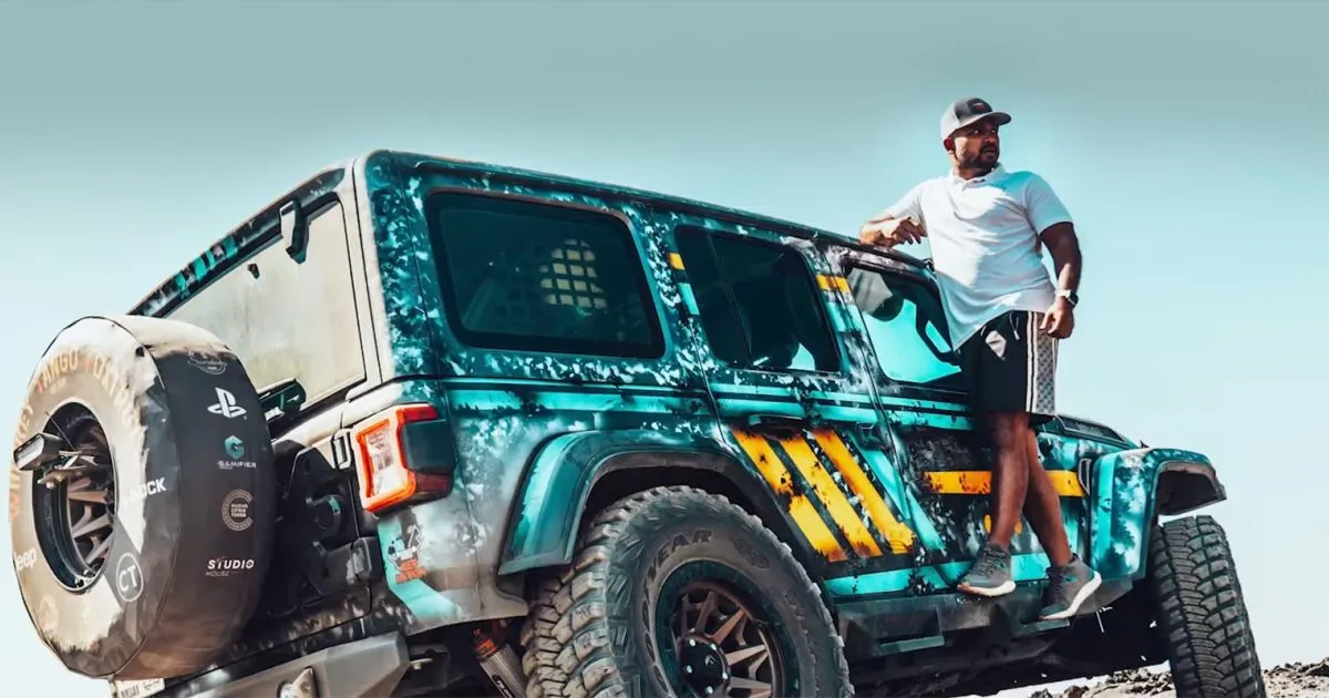 A Jeep owner standing on his customized wrapped Wrangler