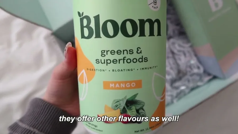 A creator holding a tub of Bloom greens in her video