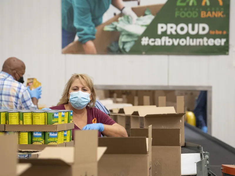 Volunteers packing food at a food bank