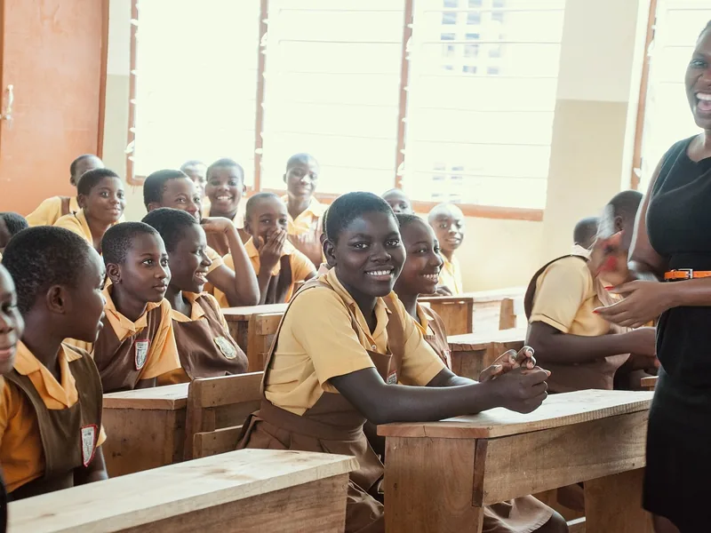 Smiling schoolchildren at their desks in a new classroom in Accra, Ghana