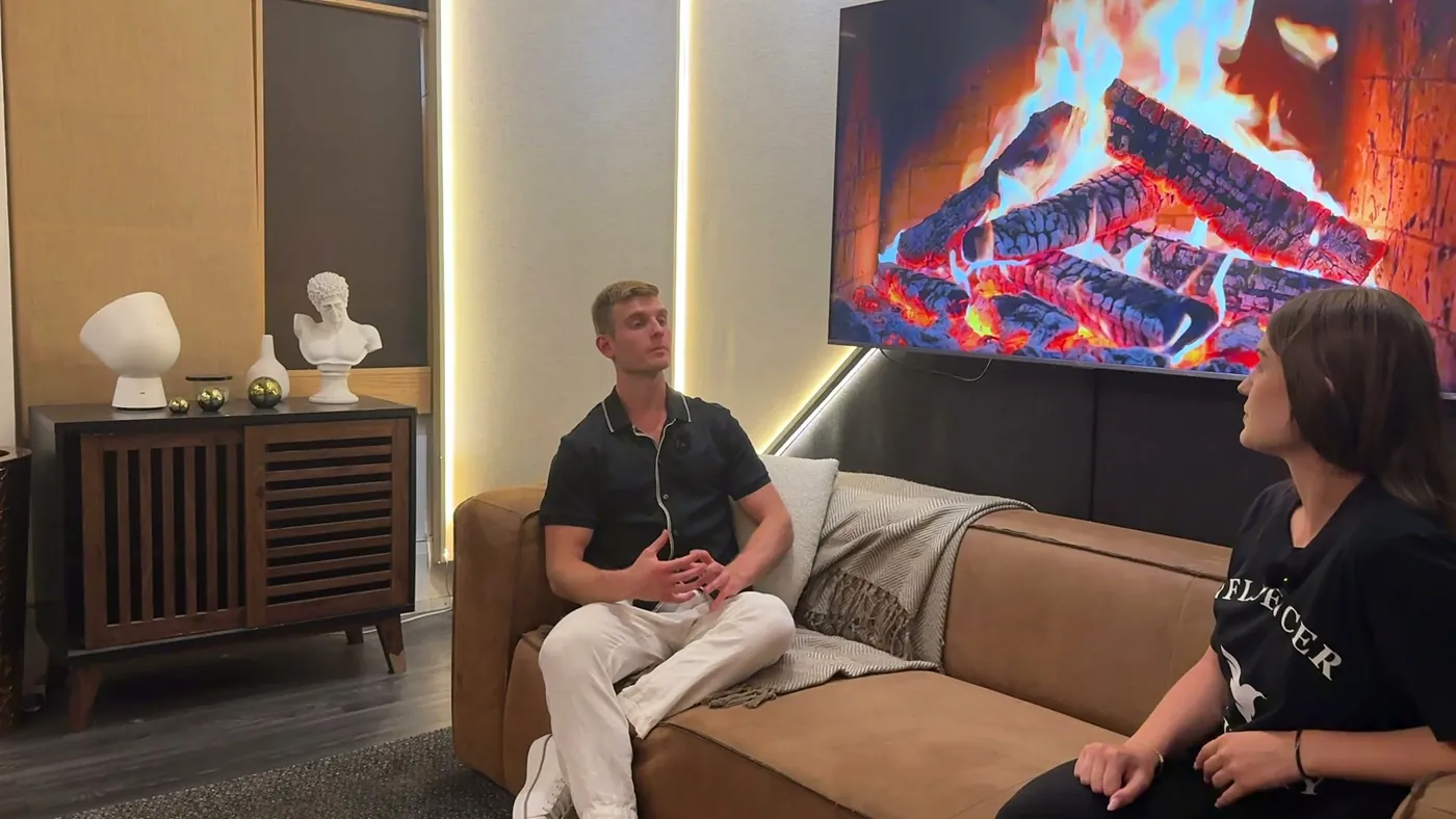 Two people talking through a question in the green room