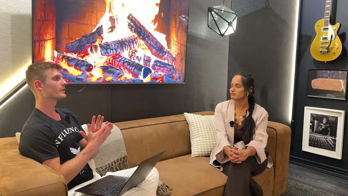Dennis interviewing a guest on the studio couch