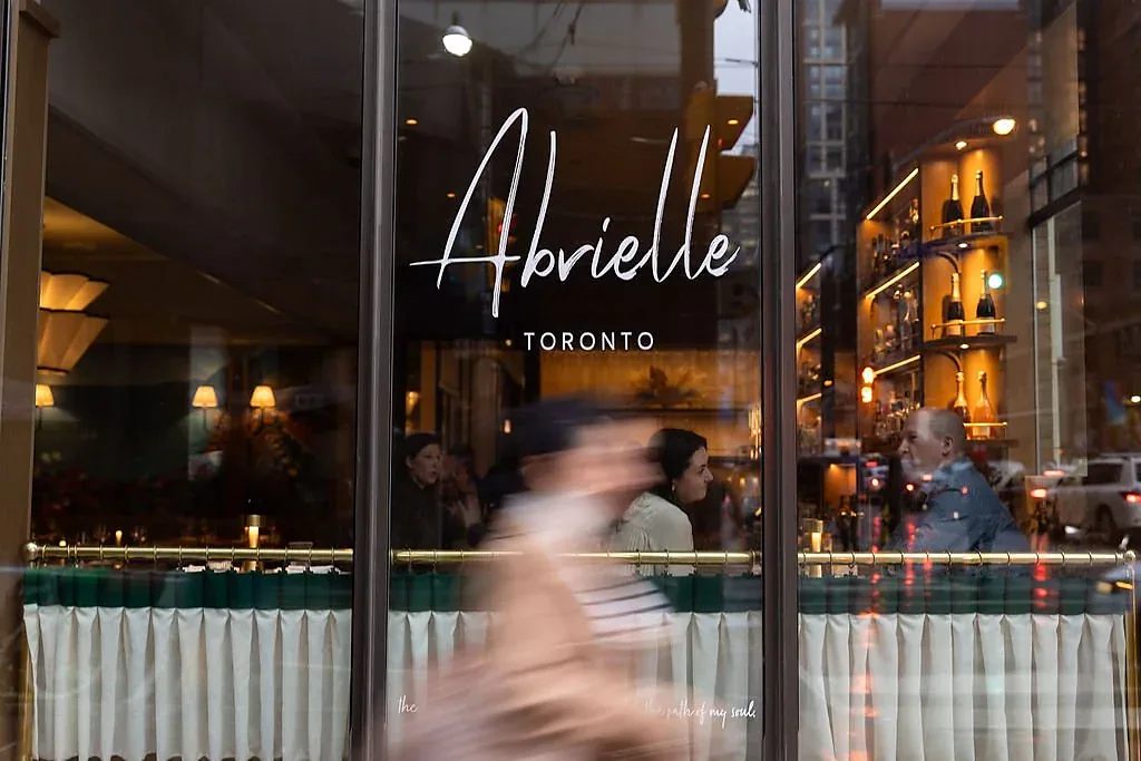 The Abrielle window on King Street West, the room lit behind the glass